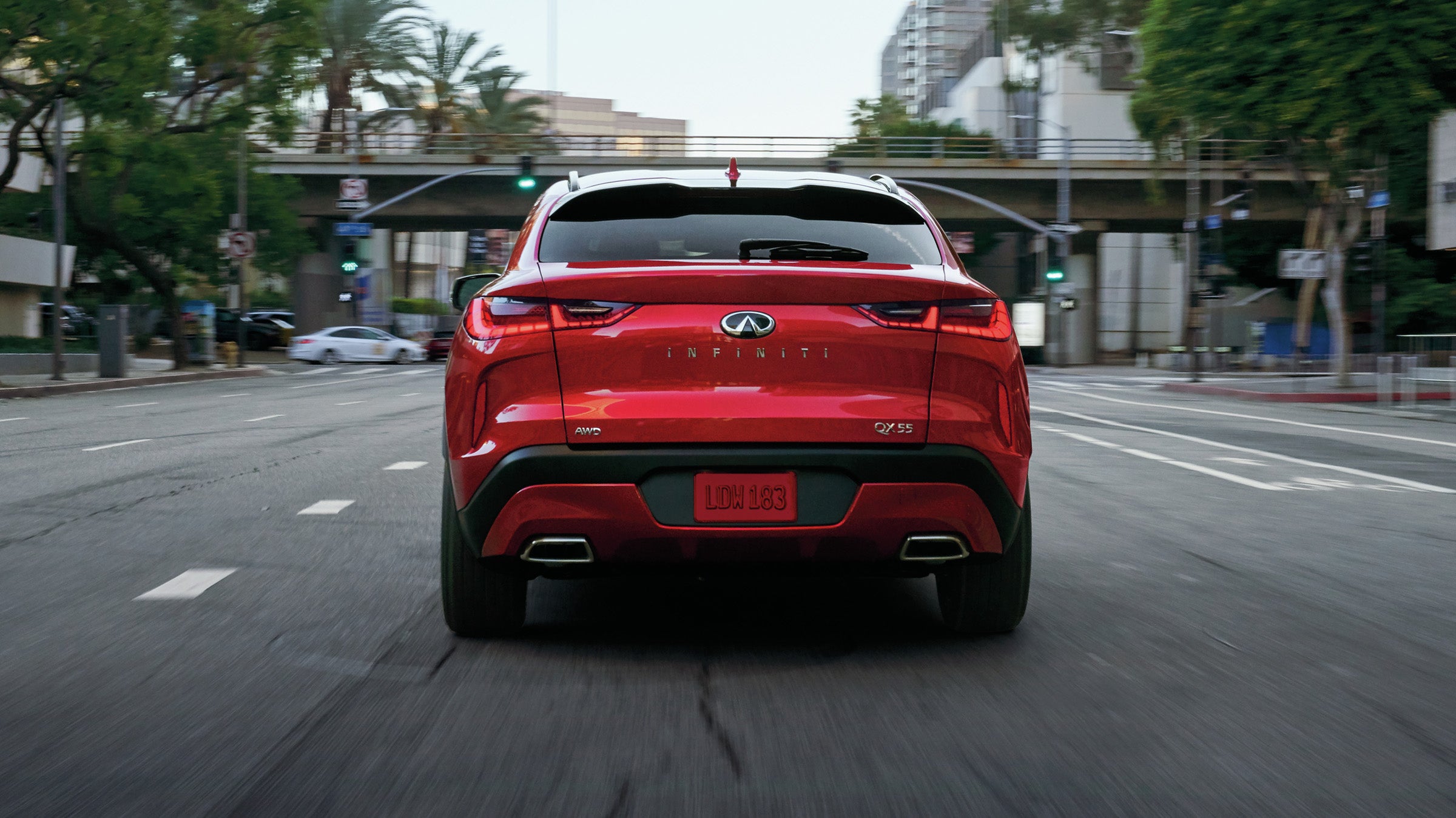 Back view of a red 2024 INFINITI QX55 crossover